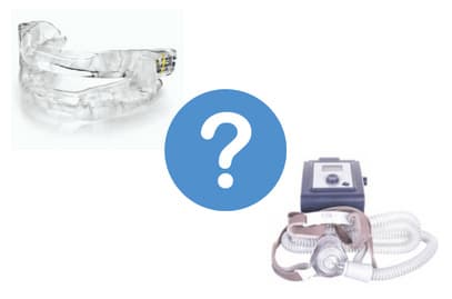 A CPAP machine beside a custom oral appliance