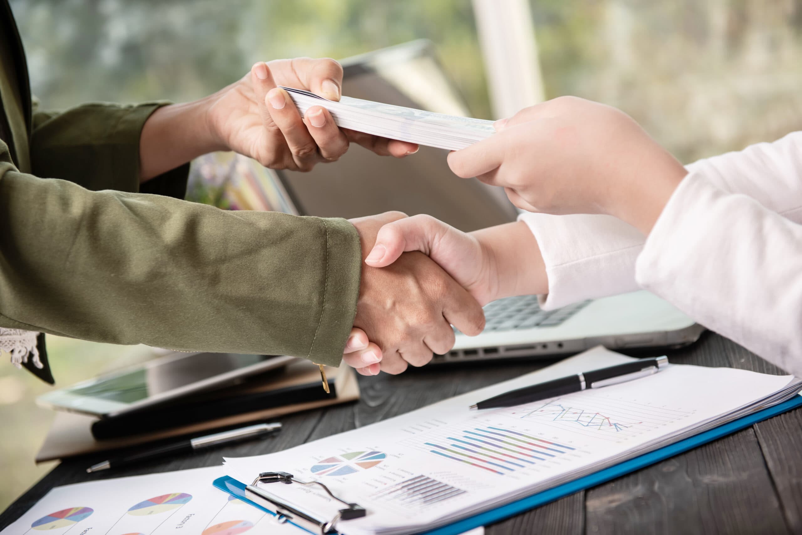 Two people shaking hands at the end of a meeting